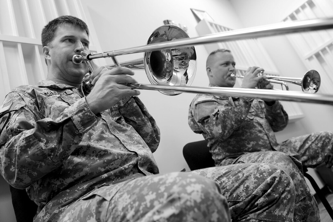 U.S. Army Staff Sgts. Jeremy McLeroy, (left), and David Newman, brass players with the Training and Doctrine Command band, perform “Amazing Grace” during practice at Fort Eustis, Va., Feb. 27, 2013. The members are part of one of the two brass quintet groups within the band, which consists of two trumpet players, and one trombone, tuba and French horn player. (U.S. Air Force photo by Staff Sgt. Ashley Hawkins/Released) 