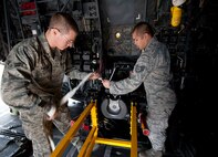U.S. Air Force Airman 1st Class Christopher Carlson, weapons load crew journeyman, right, and Staff Sgt. Bho Delos Santos, weapons load crew team chief of the 1st Special Operations Equipment Maintenance Squadron, replace a firing pin on a 105 millimeter cannon at Hurlburt Field, Fla., Feb. 27, 2013. . “I love my job - there is always something to do.” said Carlson. (U.S. Air Force photo by Senior Airman Krystal M. Garrett)