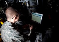 U.S. Air Force Airman 1st Class Christopher Carlson, weapons load crew journeyman of the 1st Special Operations Equipment Maintenance Squadron, looks at a technical order before replacing a firing pin on a 105 millimeter-cannon at Hurlburt Field, Fla., Feb. 27, 2013. Technical orders are step-by-step instruction manuals used to perform maintenance tasks. (U.S. Air Force photo by Senior Airman Krystal M. Garrett) 