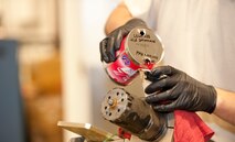 U.S. Air Force Staff Sgt. Glenn Wolford, armament systems technician shift leader of 1st Special Operations Equipment Maintenance Squadron, replaces hydraulic fuel in a 40-millimeter gun recoil cylinder at Hurlburt Field, Fla., Feb. 27, 2013. Draining and replacing hydraulic fuel is part of the servicing process for a gun recoil cylinder. (U.S. Air Force photo by Senior Airman Krystal M. Garrett)