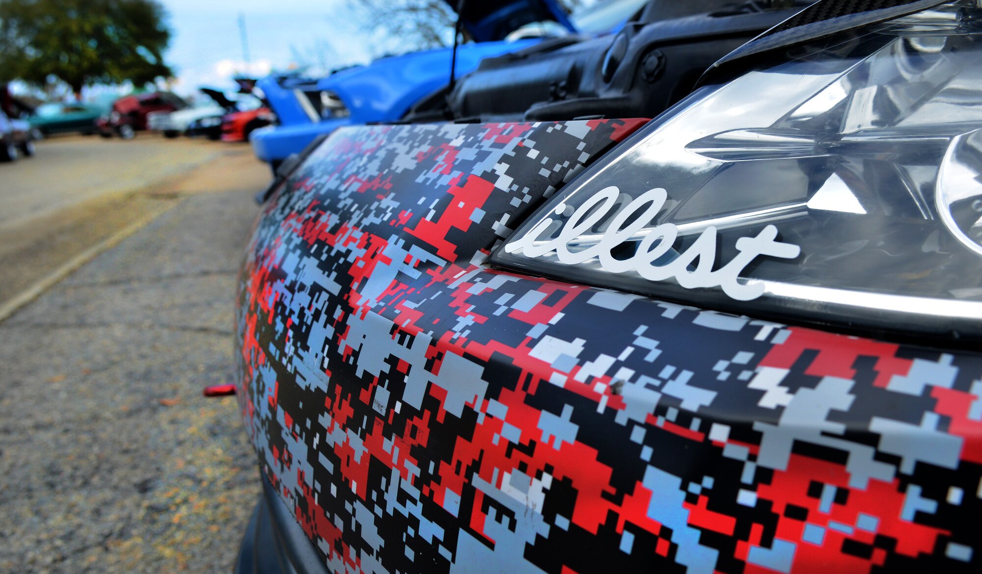 A full row of cars sit on display with paint schemes ranging from solid colors to unique patterns, Shaw Air Force Base, S.C., March 2, 2013. The event had about 50 vehicles on display that ranged from old classics to newer models. (U.S. Air Force photo by Airman 1st Class Ashley L. Gardner/ Released)