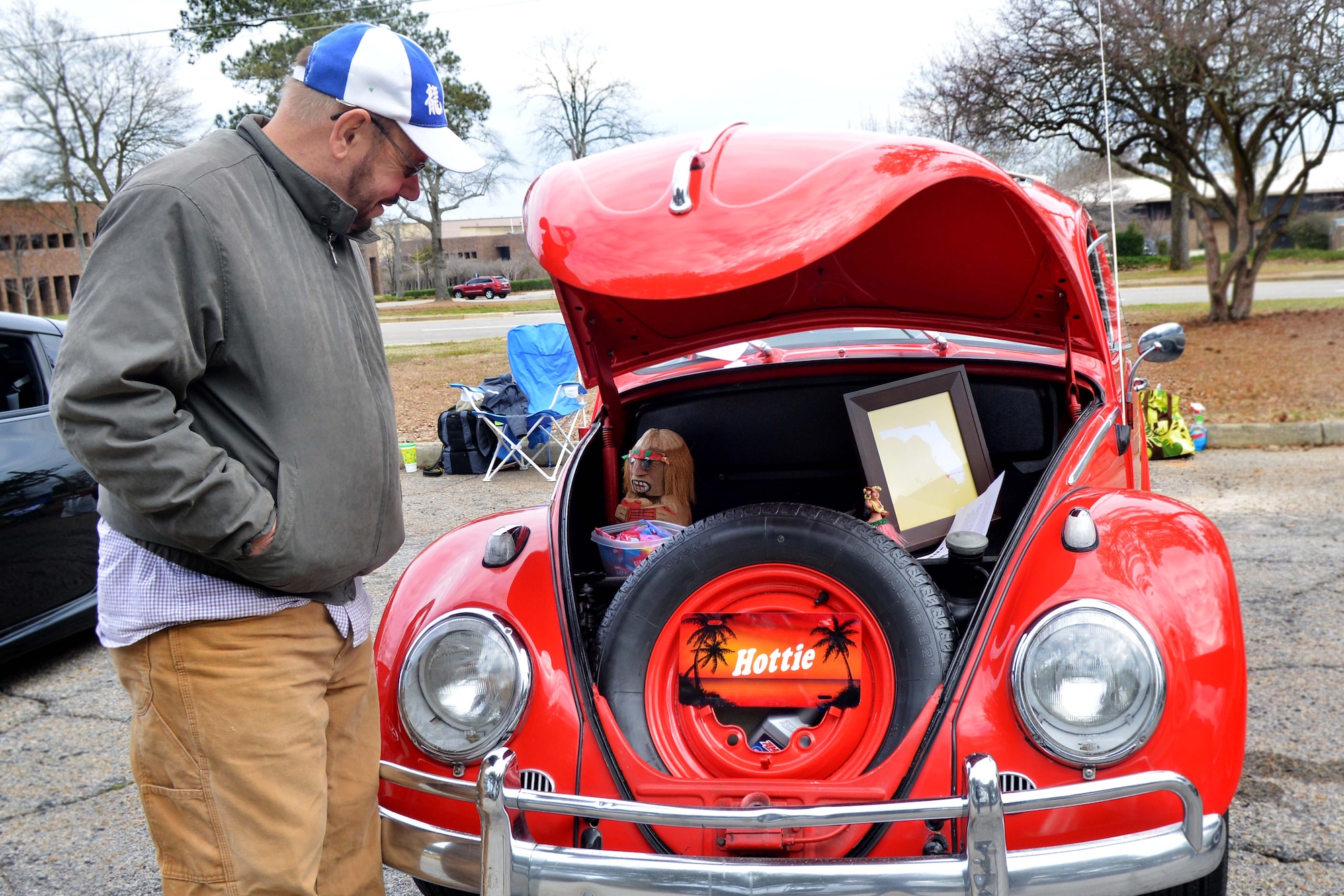 A Shaw retiree admires an older collectable car, Shaw Air Force Base, S.C., March 2, 2013. The event was held for car lovers. It had something for everyone from the classics with the basics to the more modern and advanced. (U.S. Air Force photo by Airman 1st Class Ashley L. Gardner/Released)