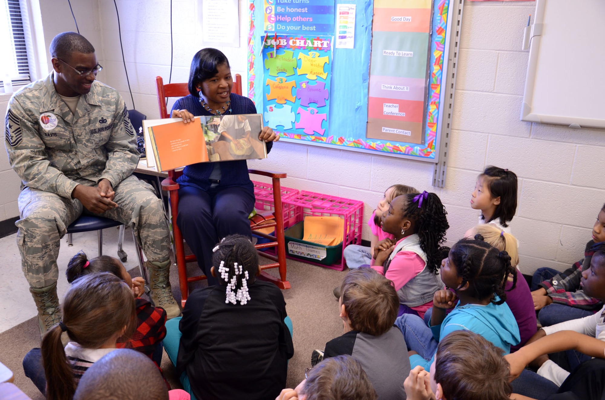 The 9th Air Force command chief, Chief Master Sgt. James Davis, and his wife, Pat Davis, read “If I Were President,” by Catherine Stier, to a group of second graders March 1 at Shaw Heights Elementary School during the school’s Read Across America Day celebration. After reading the book, the couple asked the children what they would do if they were president. Answers ranged from “get rid of homework” to “help hungry people” to “make the world out of candy.” (U.S. Air Force Photo by Staff Sgt. Amanda Currier)