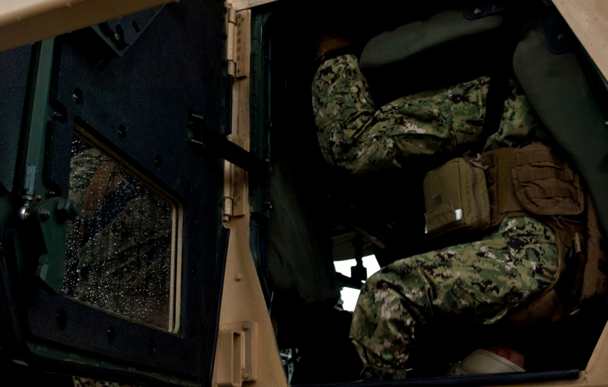 Sailors from a U.S. Navy Expeditionary Combat Camera unit prepare to exit the Humvee Egress Assistance Trainer, or HEAT, at Fort Eustis, Va., Feb. 27, 2013. Simulation technology is beginning to take a major role in military training, and the Department of Defense is turning to simulation equipment because it places Service members in scenarios to make real-life decisions without putting them in harm’s way. (U.S. Air Force Photo by Airman 1st Class R. Alex Durbin/Released)