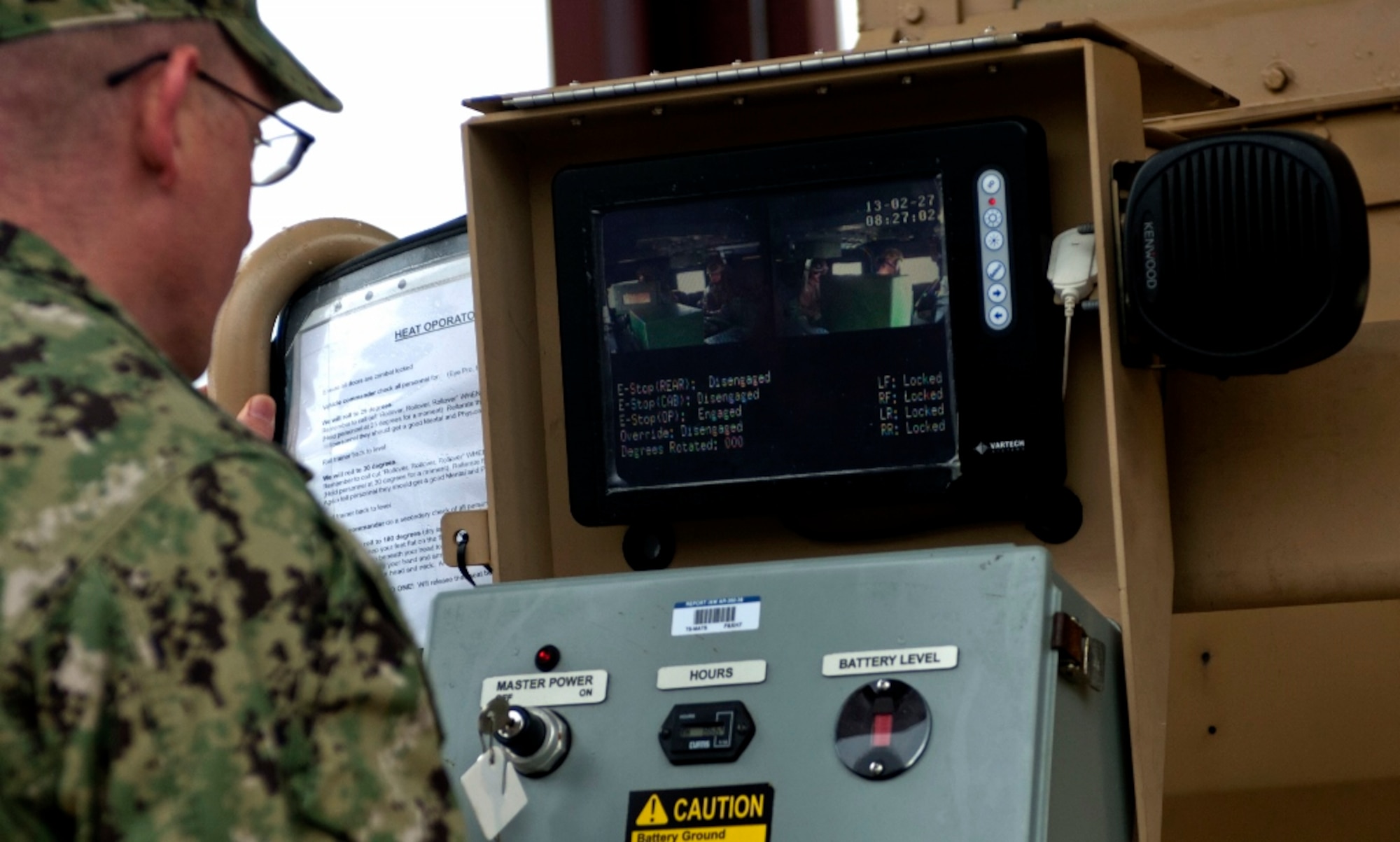 U.S. Navy Petty Officer 1st Class Gregory Juday, Expeditionary Combat Camera Training Department trainer, instructs Sailors as they train in the Humvee Egress Assistance Trainer, or HEAT, at Fort Eustis, Va., Feb. 27, 2013. The trainer is one of many simulators implemented across the Department of Defense to prepare military members for the tests of real-life emergency situations, while allowing them to experience realistic combat situations without any of the dangers. (U.S. Air Force Photo by Airman 1st Class R. Alex Durbin/Released)