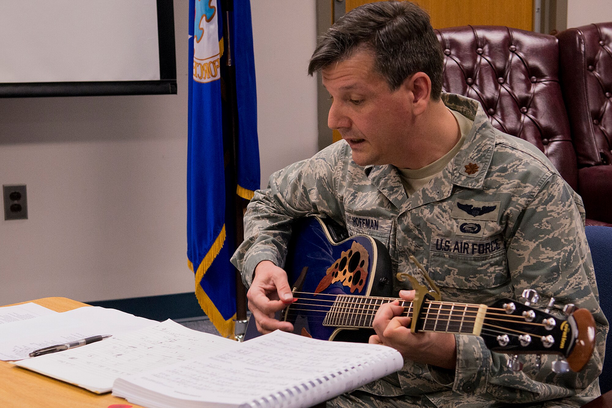 U.S. Air Force Maj. Matthew Hoffman, 307th Force Support Squadron, strums the notes of a hymnal during a morning worship service at the 307th Bomb Wing, Mar. 3, 2013, Barksdale Air Force Base, La. A service is held on every Sunday of the main Unit Training Assembly from 1030-1100 and all military and civilian members are invited to attend. (U.S. Air Force photo by Master Sgt. Greg Steele/Released)