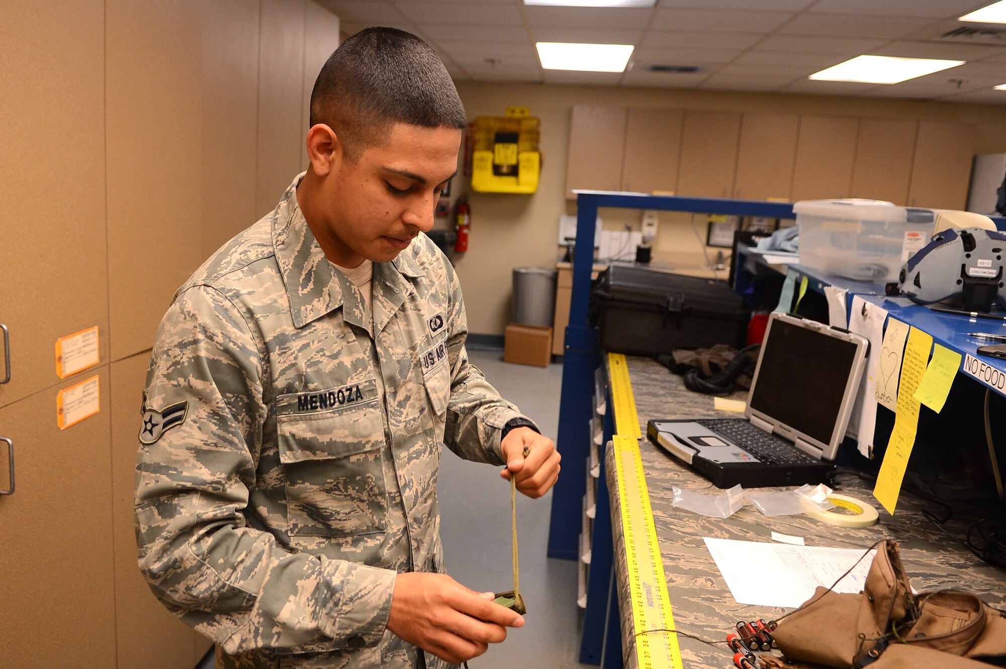 U.S. Air Force Airman 1st Class Jacob Mendoza, 55th Aircraft Maintenance Unit aircrew flight equipment technician prepares a lanyard for an anti-gravity suit at Shaw Air Force Base S.C., Feb. 27, 2013.  Aircrew flight equipment technicians are responsible for ensuring the safety of pilots through the maintenance of helmets, oxygen masks and other flight gear.  (U.S. Air Force photo by Airman 1st Class Nicole Sikorski/Released)