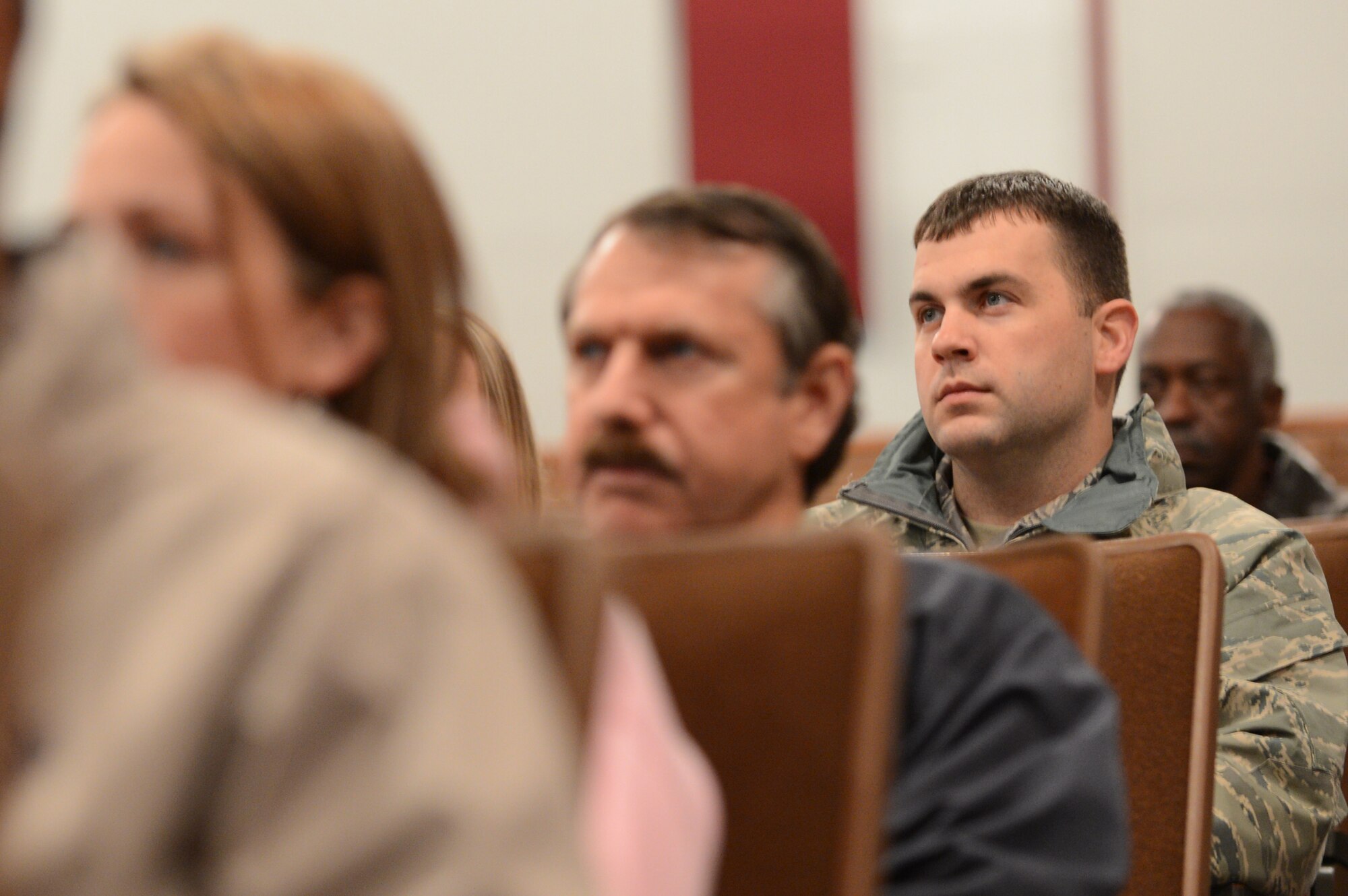 Airmen listen to a presentation from U.S. Air Force Col. Clay Hall, 20th Fighter Wing commander, at Shaw during a town hall style meeting at Shaw Air Force Base, S.C., Feb., 28, 2013.  During the meeting, Hall spoke about local impacts of sequestration, military contracting at Shaw, renovations in the single Airmen dorms and other upcoming projects for modernization at Shaw. (U.S. Air Force photo by Airman 1st Class Nicole Sikorski/Released)