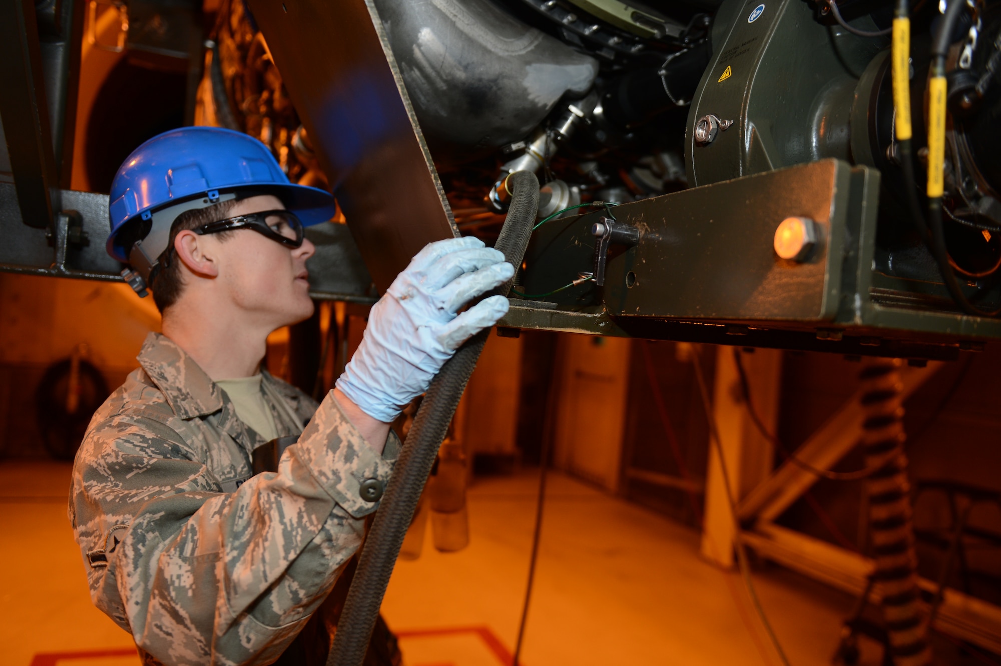 SPANGDAHLEM AIR BASE, Germany –Airman Jeremy Rushing, 52nd Component Maintenance Squadron aerospace propulsion technician from Charleston S.C., pumps oil into an F-16 Fighting Falcon engine Feb. 27, 2013. This is part of a post engine reconstruction inspection, after a full engine reconstruction, all liquids are drained and then replaced for testing. (U.S. Air Force photo by Airman 1st Class Gustavo Castillo/Released)