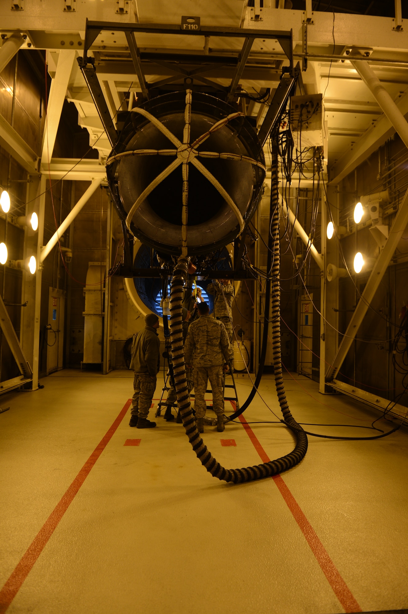 SPANGDAHLEM AIR BASE, Germany – Aerospace propulsion technicians perform maintenance on an F-16 Fighting Falcon engine in an engine test cell Feb. 27, 2013. The test cell inspects approximately 100 engines per year.  The engine diagnostic consisted of checking temperature, air flow, fuel and leaks. (U.S. Air Force photo by Airman 1st Class Gustavo Castillo/Released)