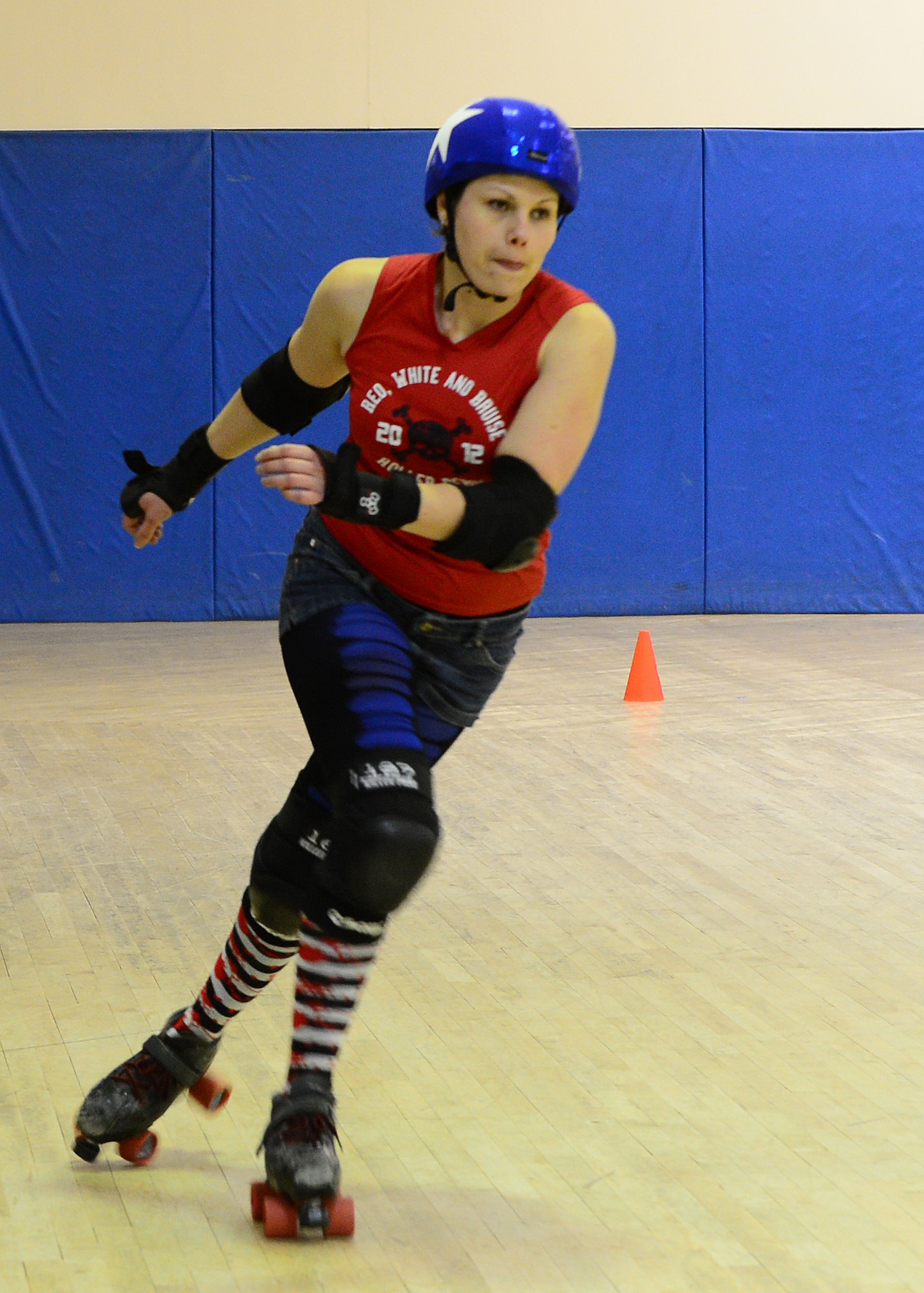 ROYAL AIR FORCE LAKENHEATH, England - Kay Daniels, Red, White and Bruises Rollers derby player, skates around the track to warm-up before a practice scrimmage Feb. 21, 2013. The Red, White and Bruises Rollers team practice three times a week at the RAF Lakenheath skating rink. (U.S. Air Force photo by Staff Sgt. Stephanie Mancha)