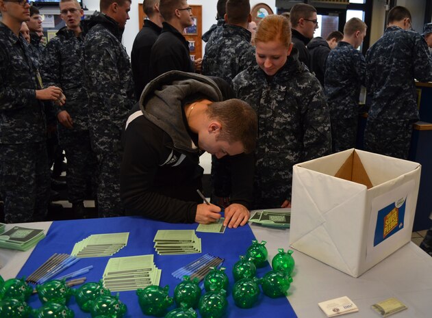 Petty Officer 3rd Class Peter Anderer, a machinist’s mate assigned to Naval Nuclear Power Training Commandsigns a “Savers Pledge” card at the Naval Weapons Station galley Feb 28, 2013. Military Saves is a joint force initiative that encourages Sailors and Airmen to begin saving for their futures early in their careers. (U.S. Navy photo/Petty Officer 2nd Class Christopher A. Baker)
