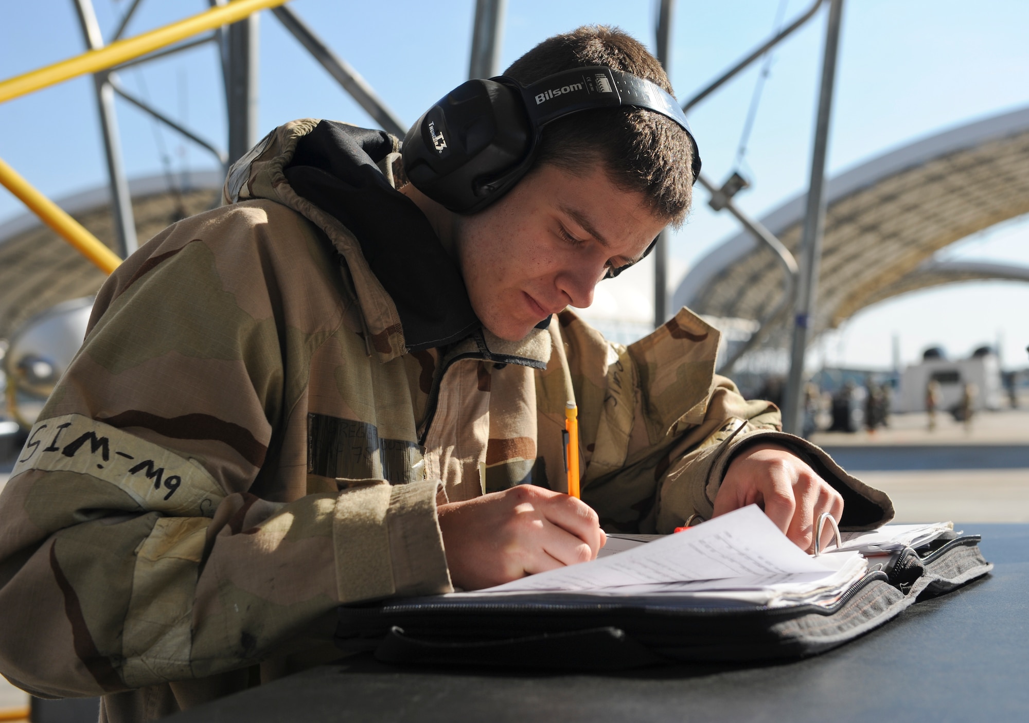 U.S. Air Force Senior Airman Quinten Gregersen, 23d Maintenance Operations Squadron weapons load crew member, logs data after an inspection during a phase II operational readiness exercise (ORE) Feb. 28, 2013, at Moody Air Force Base, Ga. OREs test Airmen’s ability to perform in a simulated deployed environment. (U.S. Air Force photo by Airman Alexis Grotz/Released)