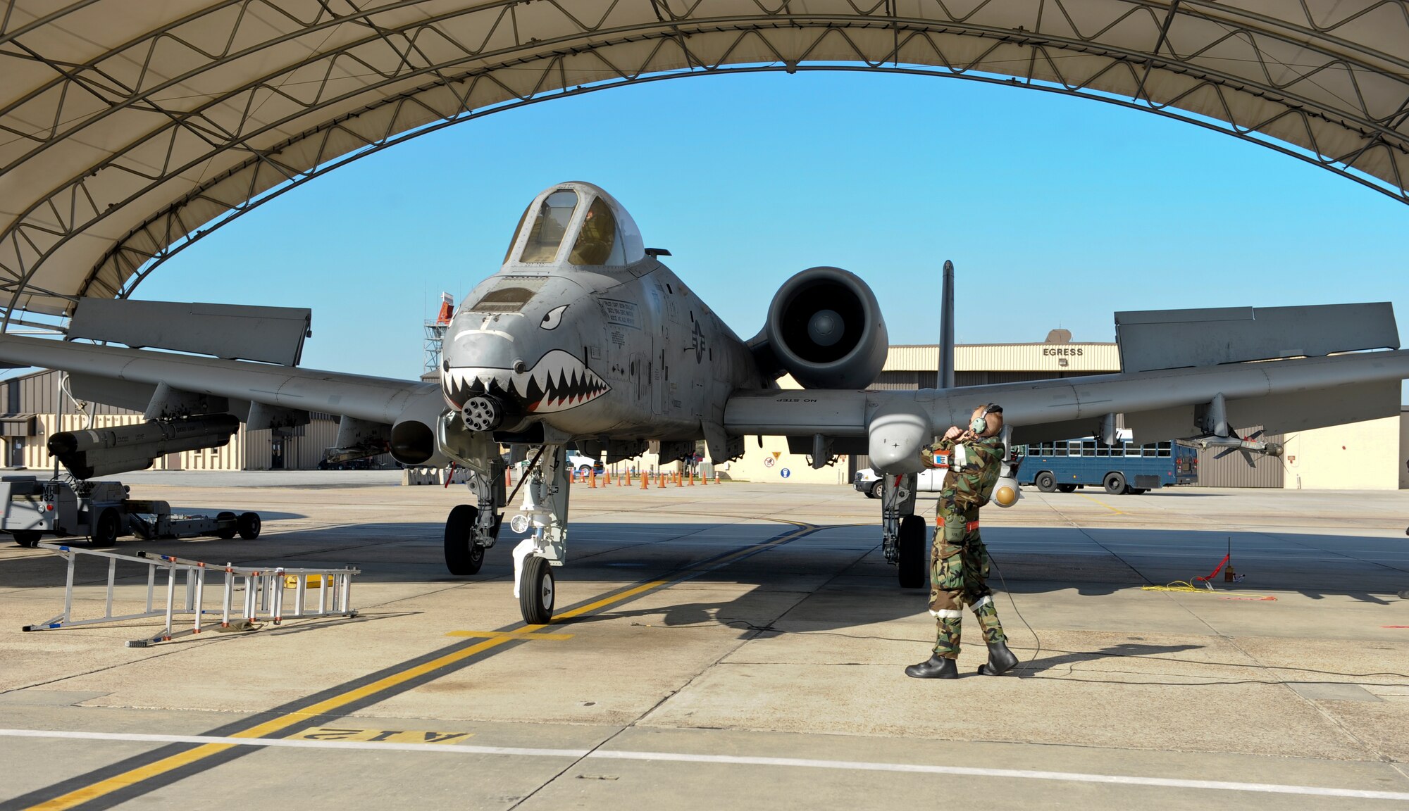U.S. Air Force Airman 1st Class Kalib McBride, 23d Aircraft Maintenance Squadron crew chief, marshals an A-10C Thunderbolt II during a phase II operational readiness exercise Feb. 28, 2013, at Moody Air Force Base, Ga. McBride usies hand signals to let the pilot know where to stop the aircraft.(U.S. Air Force photo by Airman Alexis Grotz/Released)