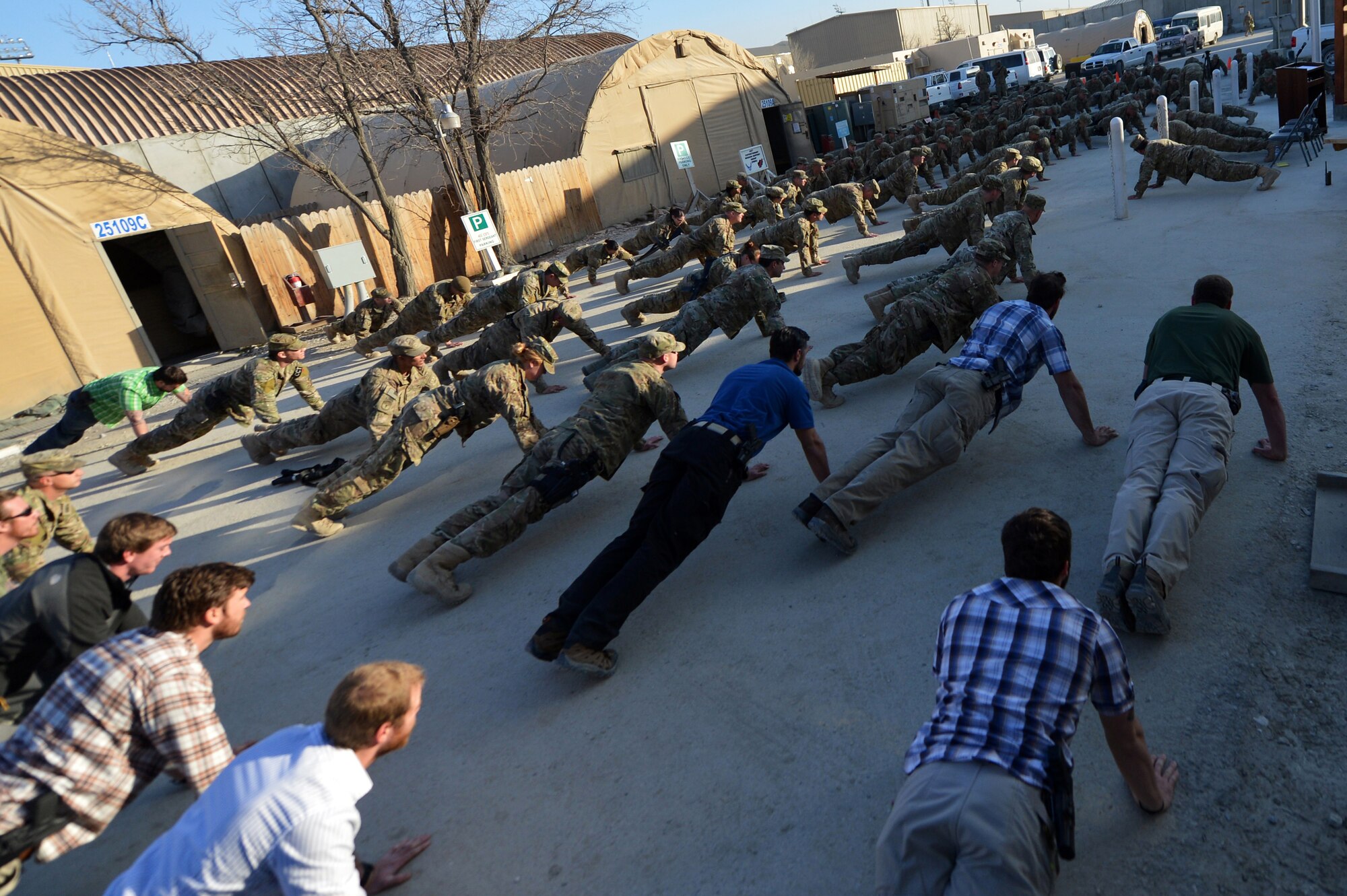 Members of Team Bagram honor Airmen who have fallen in support of Operation Enduring Freedom at Camp Cunningham on Bagram Airfield, Afghanistan, March 5, 2013.  Directly following the ceremony, the BAF members participated in group push-ups to honor teamwork and fellow comrades. (U.S. Air Force photo/Senior Airman Chris Willis)                            