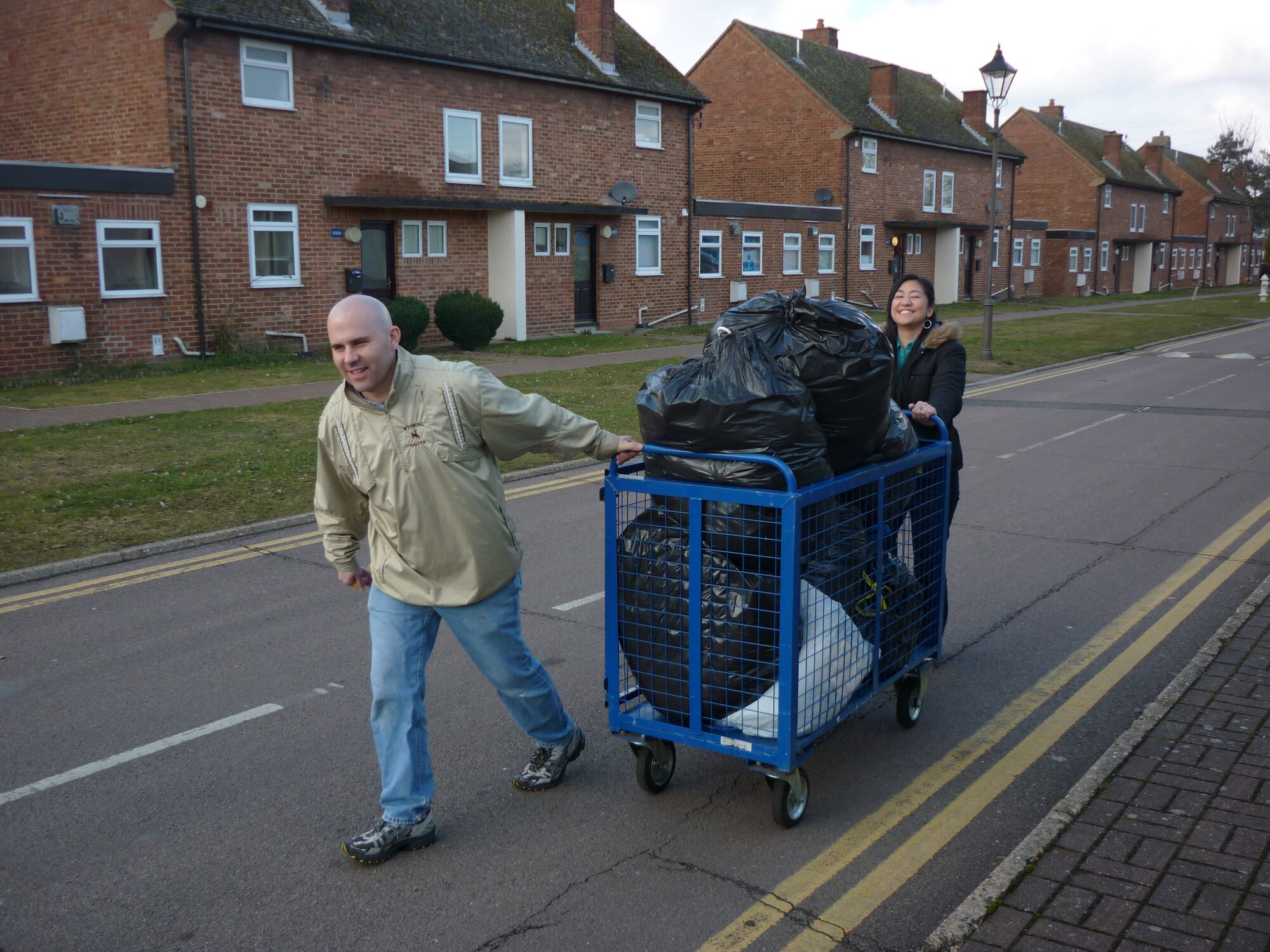 ROYAL AIR FORCE LAKENHEATH, England -- 1st Lt. Angela Naval, 48th Sexual Assault Response coordinator, and 1st Lt. Tommy Rutherford, 48th Logistics Readiness Squadron material management flight commander, transfer donated items from the RAF Lakenheath Airman's Attic to clothing-recycle bins during a Company Grade Officers Council service project Feb. 25, 2010. The 48th FW will host the first Liberty Pride Day on base and throughout the local area April 27, 2013. (U.S. Air Force photo by 2nd Lt. Ashley Skillman)