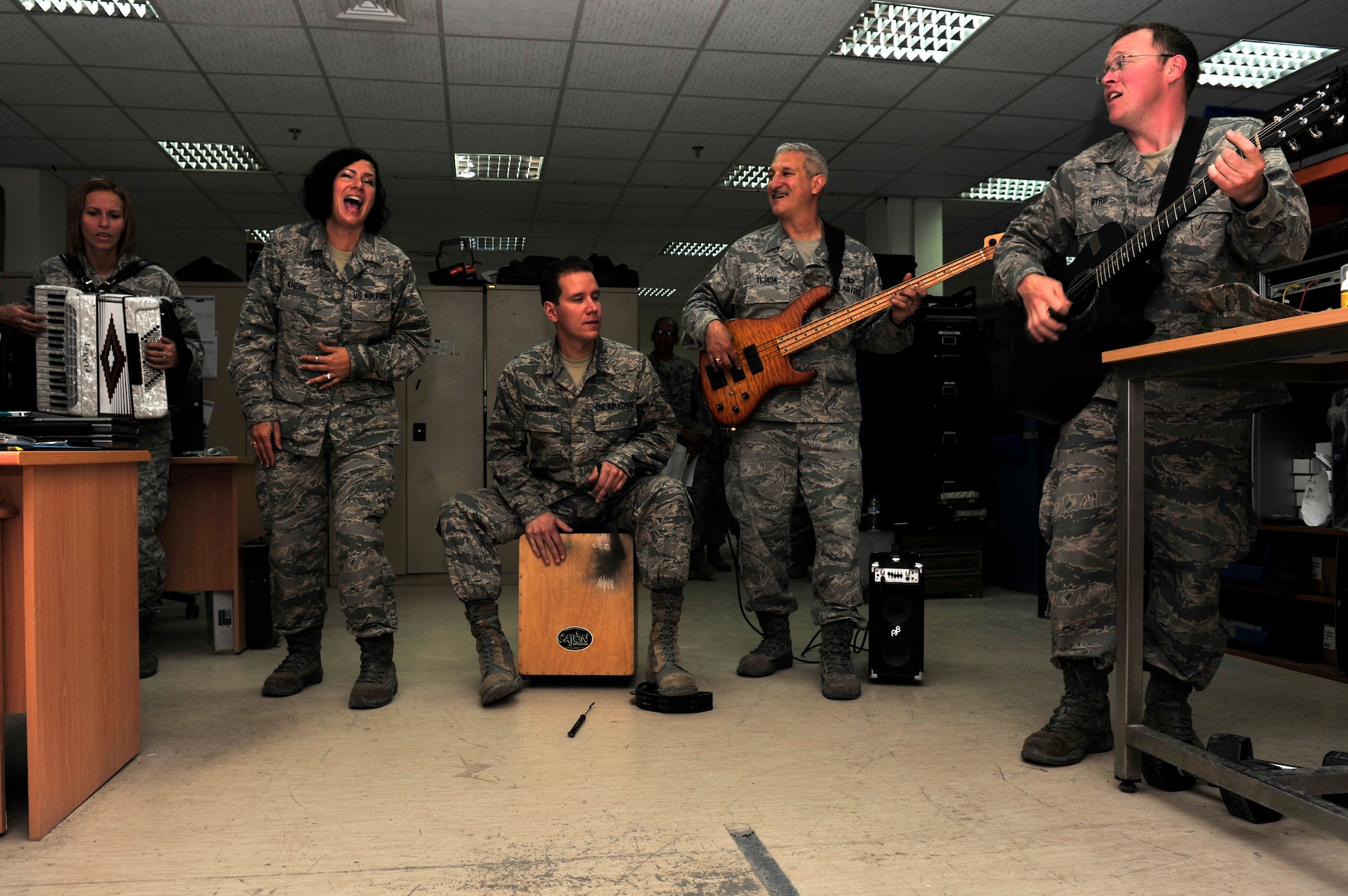 The U.S. Air Forces Central Band “Total Force” performs for members of the 380th Expeditionary Communications Squadron during a “strolling performance” at an undisclosed location in Southwest Asia Feb. 26, 2013. The band performed at more than 10 workcenters during their final week-long tour before redeploying to Robins Air Force Base, Ga. (U.S. Air Force photo by Tech. Sgt. Christina M. Styer/Released)
