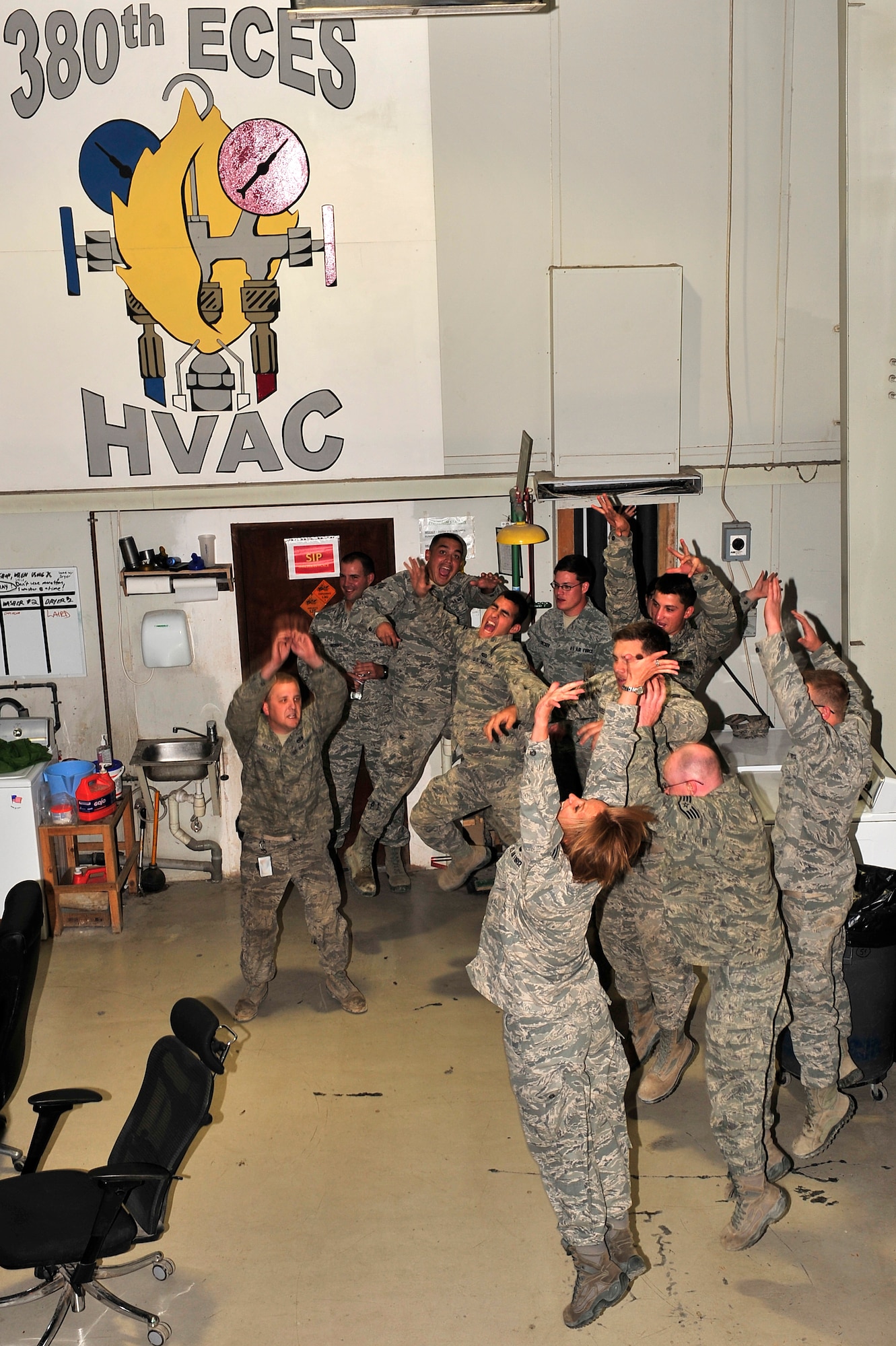 U.S. Air Force Senior Airman Michelle Hooper, U.S. Air Forces Central Band “Total Force” vocalist and keyboards, interacts with members of the 380th Expeditionary Civil Engineer Squadron during a “strolling performance” at an undisclosed location in Southwest Asia Feb. 26, 2013. The band performed at more than 10 workcenters during their final week-long tour before redeploying to Robins Air Force Base, Ga. (U.S. Air Force photo by Tech. Sgt. Christina M. Styer/Released)