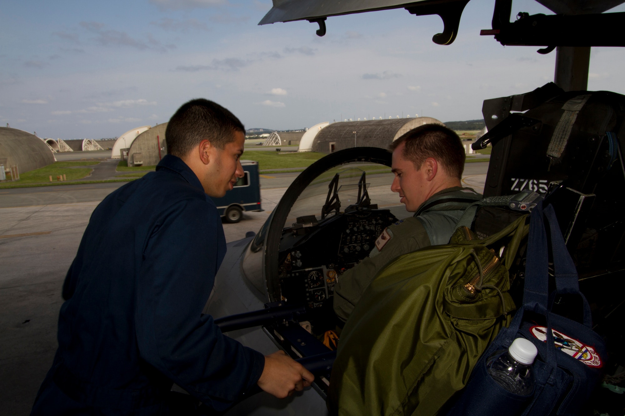 Airman 1st Class Agustin Gonzales, 44th Fighter Squadron aircraft maintainer, performs final pre-flight checks with Capt. Jeffery Thomason, 44th FS pilot, before a mission on Kadena Air Base, Japan. Gen. Herbert Carlisle, Pacific Air Forces commander, recently announced Kadena's 44th FS "Vampire Bats" as winner of the Raytheon Trophy for 2012. (Courtesy photo by Jake Melampy)