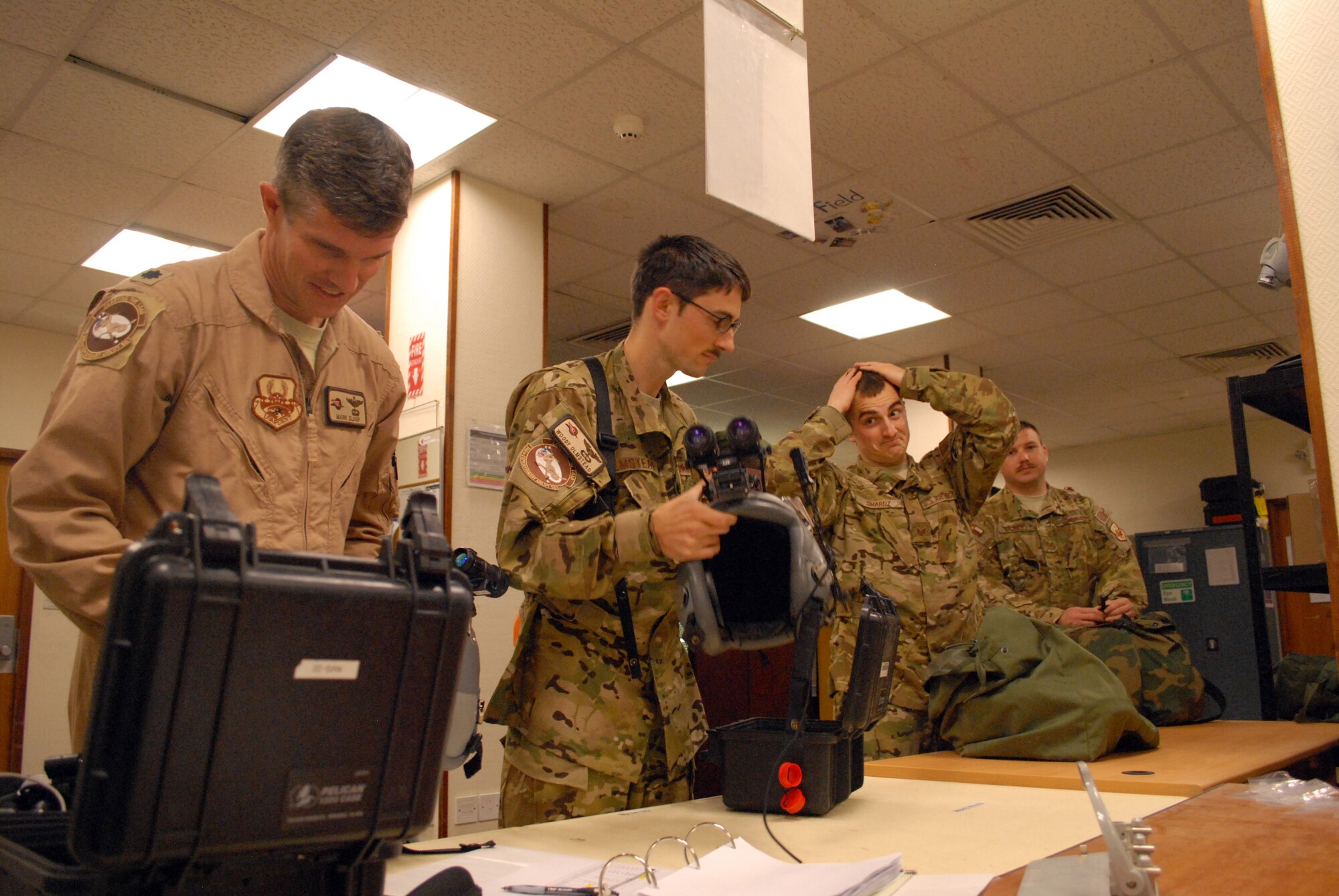 SOUTHWEST ASIA -- Lt. Col. Mark Sloop, Capt. Roland Olmstead, Staff Sgt. Mitchel Smardz and Staff Sgt. Lance Vasquez, 746th Expeditionary Airlift Squadron, inspect their life support equipment before their mission aboard a C-130, Mar. 4. Members of the 746th EAS, comprised of Reservists from the 908th Airlift Wing, Maxwell AFB, Ala., and 440th Airlift Wing, Pope Field, N.C., prepare to transport cargo downrange in the U.S. Central Command area of responsibility. (U.S. Air Force photo/Master Sgt. Christian Michael)