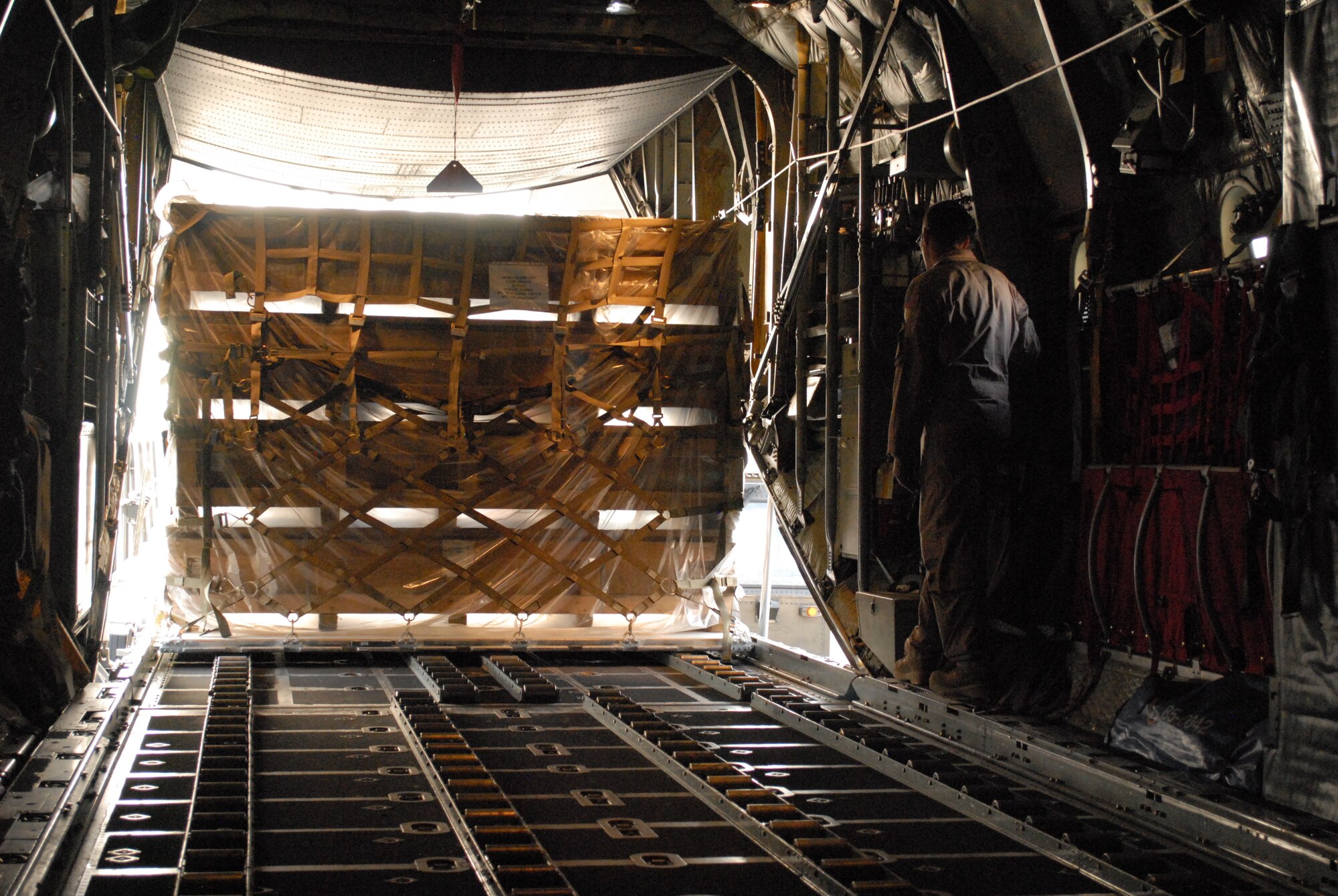 SOUTHWEST ASIA -- Senior Airman Nathan Basham, 746th Expeditionary Airlift Squadron duty loadmaster, monitors a pallet being loaded onto a C-130, Mar. 4. Members of the 746th EAS and Expeditionary Aircraft Maintenance Squadrons, comprised of Reservists from the 908th Airlift Wing, Maxwell AFB, Ala., and 440th Airlift Wing, Pope Field, N.C., prepare to transport cargo downrange in the U.S. Central Command area of responsibility. (U.S. Air Force photo/Master Sgt. Christian Michael)