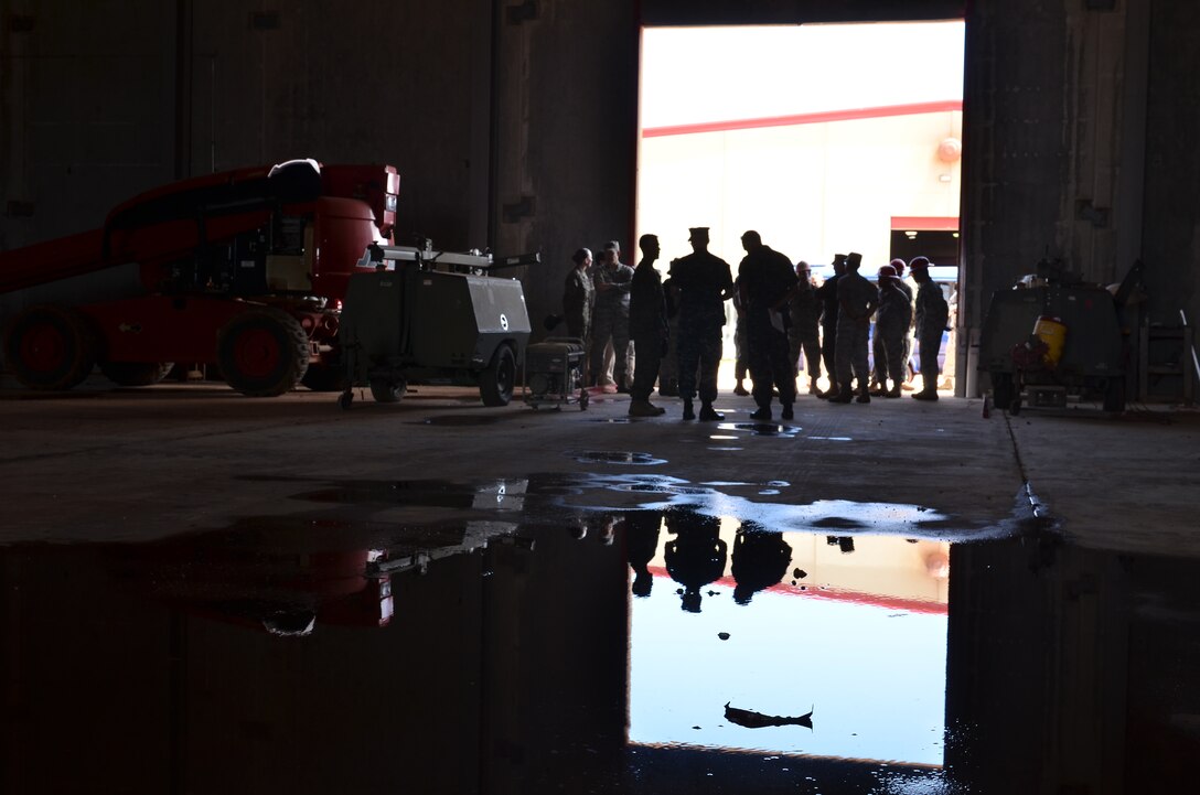 Airmen from the 554th RED HORSE Squadron brief U.S. Air Force, Marine Corps and Navy headquarters leadership on upcoming Pacific Regional Training Center developments during a tour on Northwest Field, Guam, Feb. 28, 2013. The leaders toured base structures and developments to gain insight on successes and challenges within Joint Region Marianas. (U.S. Air Force photo Staff Sgt. Alexandre Montes/Released)