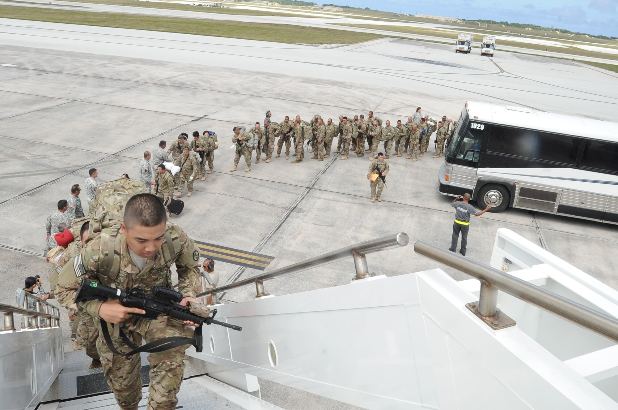 Members of the Guam Army National Guard, 1st Battalion, 294th Infantry Regiment board an aircraft at Andersen Air Force Base, Guam, March 2, 2013, for a deployment to Afghanistan. The 36th Logistics Readiness Squadron served as the lead organization in executing the logistical portion of deploying about 600 Soldiers. (U.S. Air Force photo by Airman 1st Class Adarius Petty/Released)