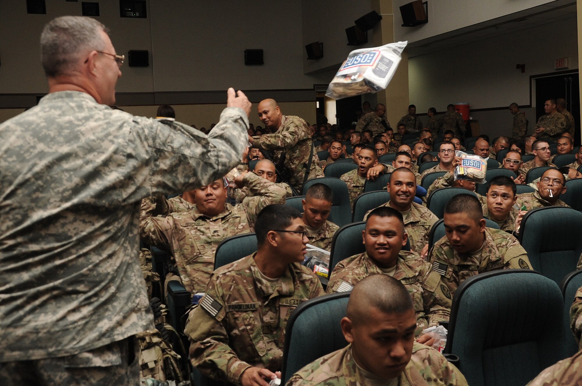 Army Chap. (Capt.) Richard Kelley, Guam National Guard, passes out Meals, Ready-to-Eat to deploying Soldiers at Andersen Air Force Base, Guam, March 2, 2013. The 36th Logistics Readiness Squadron served as the lead organization in executing the logistical portion of deploying about 600 Soldiers. (U.S. Air Force photo by Airman 1st Class Adarius Petty/Released)