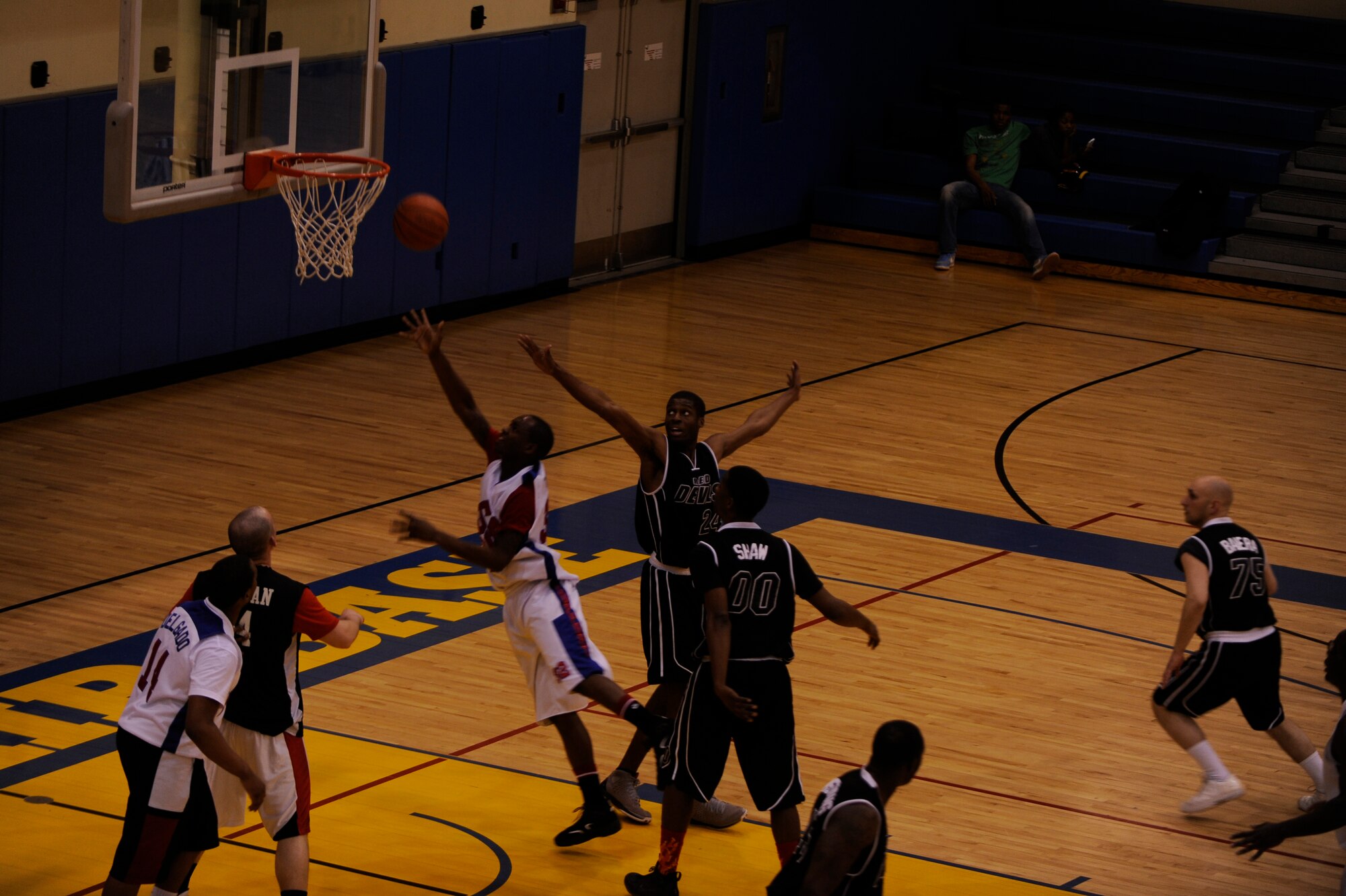Troy Massey, 8th Force Support Squadron attempts a layup as Maurice Roberson, 8th Civil Engineer Squadron, tries to block the shot during the intramural championship game at Kunsan Air Base, Republic of Korea, March 1, 2013. The 8th CES won the basketball championship, 49 to 42. (U.S. Air Force photo by Senior Airman Marcus Morris/Released)