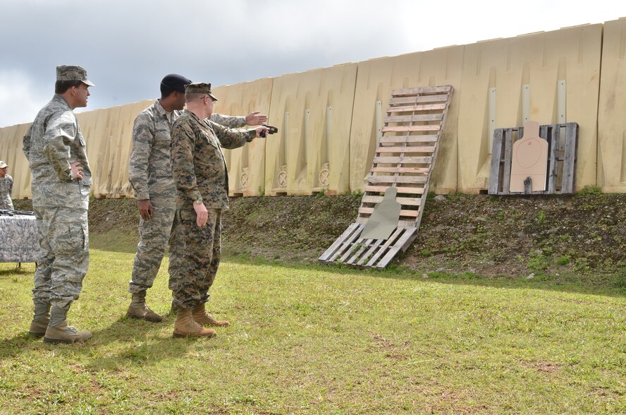 (Left) Maj. Gen. Timothy Byers, Air Force Civil Engineer, Headquarters U.S. Air Force, watches (center) Staff Sgt. Jason Brown, 736th Security Forces Squadron Commando Warrior instructor, demonstrate how to use a Taser to (right) U.S. Marine Corps Maj. Gen. James Kessler, Marine Corps Installations Command commander, during a tour of the Pacific Regional Training Center on Northwest Field, Guam, Feb. 27, 2013. The leaders toured base structures and developments to gain insight on successes and challenges within Joint Region Marianas. (U.S. Air Force photo Staff Sgt. Alexandre Montes/Released)