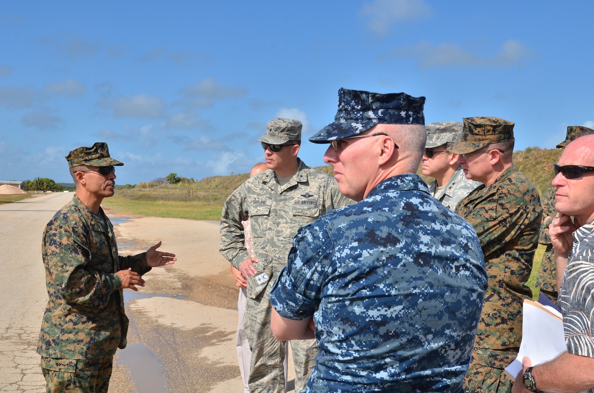 (Left) U.S. Marine Corps Maj. Darren Alvarez, Joint Guam Program Office, explains the current progress of flightline construction to U.S. Air Force, Marine Corps and Navy headquarters leadership during a tour at Andersen Air Force Base, Guam, Feb. 27, 2013. The leaders toured base structures and developments to gain insight on successes and challenges within Joint Region Marianas. (U.S. Air Force photo Staff Sgt. Alexandre Montes/Released)