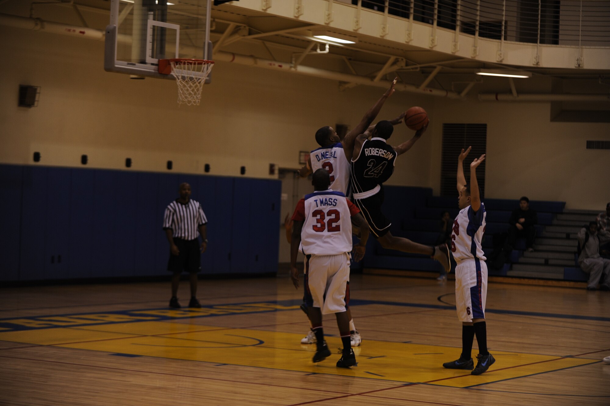 Maurice Roberson, right, 8th Civil Engineer Squadron, attempts a shot as Nedward Neal, 8th Force Support Squadron, tries to block him during the base intramural basketball championship at Kunsan Air Base, Republic of Korea, March 1, 2013. The 8th CES defeated 8th FSS 49-42. (U.S. Air Force photo by Senior Airman Marcus Morris/Released)