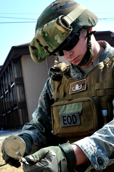 Airman 1st Class Shawn Hewitt, 51st Civil Engineer Squadron Explosive Ordnance Disposal technician, prepares a tool to be used in the disarming of an unexploded ordnance in an exercise at Osan Air Base, Republic of Korea, Feb. 21, 2013. An engineering technician will attach with an EOD team as part of an Airfield Damage Assessment Team in the case of a contingency to relay any information regarding damage so it can be fixed as well as help hold a cordon or secure an area. (U.S. Air Force photo/Airman 1st Class Alexis Siekert)