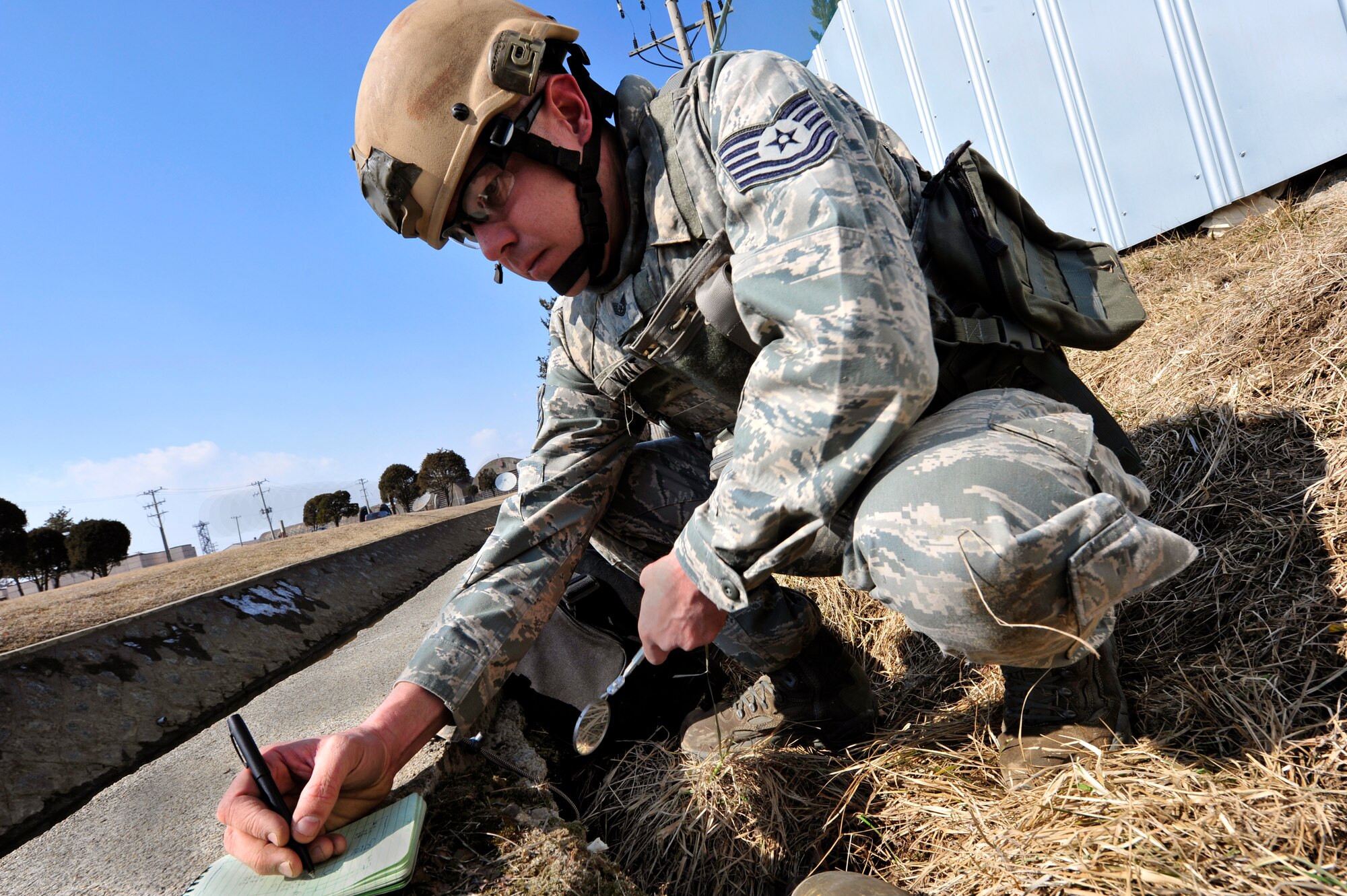 Tech. Sgt. Tobin Bryant, 51st Civil Engineer Squadron explosive ordnance disposal flight NCO in charge, records information about an unexploded ordnance in an exercise at Osan Air Base, Republic of Korea, Feb. 21, 2013. The information was then used to reference EOD databases to determine the proper protocol for disposal. (U.S. Air Force photo/Airman 1st Class Alexis Siekert)