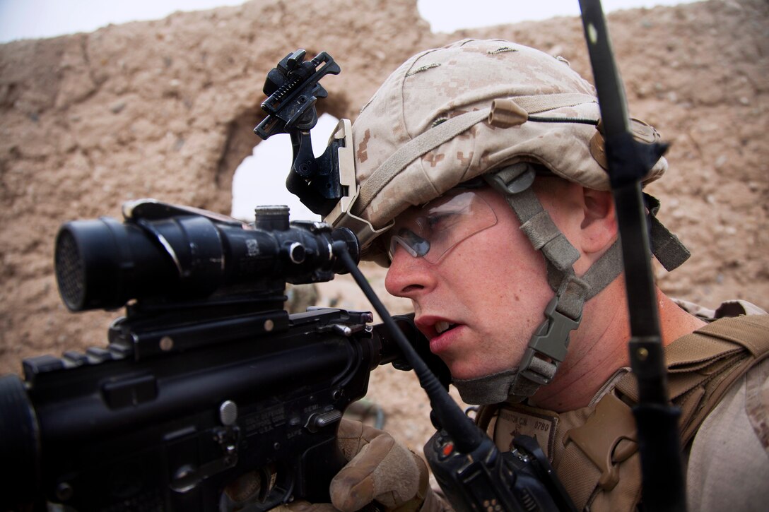 U.S. Marine Corps Cpl. Chris Hoisington uses his weapon's optic lens to scan for enemy positions during Operation Bullseye in Kajaki in Afghanistan's Helmand province, Feb. 27, 2013. Hoisington a radio operator, is assigned to the 2nd Battalion, 7th Marine Regiment, Regimental Combat Team 7.
