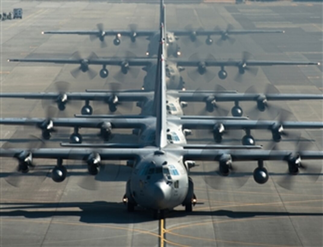Five U.S. Air Force C-130 Hercules cargo aircraft line up before taking off during readiness week at Yokota Air Base, Japan, on Feb. 21, 2013.  The 374th Airlift Wing uses C-130s to support combatant commanders in the Pacific region.  