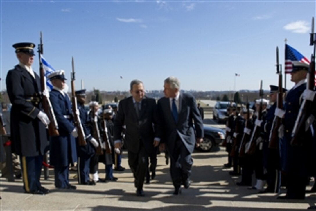 Secretary of Defense Chuck Hagel, right, escorts Israeli Minister of Defense Ehud Barak through an honor cordon and into the Pentagon on March 5, 2013.  Hagel and Barak will meet to discuss national security items of interest to both nations.  