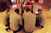 Four servicemembers kneel before a memorial set up for Cpl. Christopher M. Monahan Jr. and Lance Cpl. Dale W. Means, motor transportation operators with Combat Logistics Battalion 2, 2nd Marine Logistics Group, aboard Camp Lejeune, N.C., Feb. 22, 2013. The battalion spent nearly seven months providing tactical logistics support to units in Helmand province, Afghanistan. 