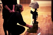 The wife of Lance Cpl. Dale W. Means, a motor transportation operator with Combat Logistics Battalion 2, 2nd Marine Logistics Group, who was killed while supporting tactical logistics operations in Helmand province, Afghanistan, mourns at the site of a memorial set up aboard Camp Lejeune, N.C., Feb. 22, 2013. CLB-2 held the memorial to honor the sacrifices of the Marines who died while serving with the battalion during its deployment to Afghanistan.