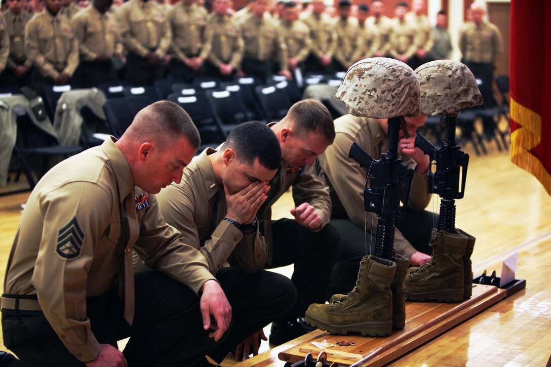 Four Marines with Combat Logistics Battalion 2, 2nd Marine Logistics Group pay their respects to two fallen comrades during a memorial service aboard Camp Lejeune, N.C., Feb. 22, 2103. Cpl. Christopher M. Monahan Jr. and Lance Cpl. Dale W. Means, motor transportation operators with the battalion, who were killed while providing tactical logistics support to units serving in Helmand province, Afghanistan, November 2012.