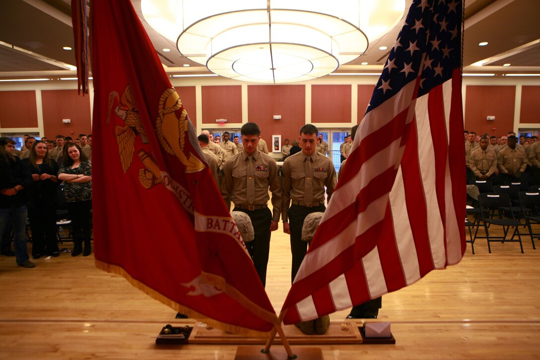 Marines stand before a memorial for Cpl. Christopher M. Monahan Jr. and Lance Cpl. Dale W. Means, motor transportation operators with Combat Logistics Battalion 2, 2nd Marine Logistics Group, set up aboard Camp Lejeune, N.C., Feb. 22, 2013. The two Marines were killed while supporting combat operations in Helmand province, Afghanistan, November 2012. 