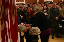 Family members mourn at a memorial set up for two fallen Marines who served with Combat Logistics Battalion 2, 2nd Marine Logistics Group during the unit’s 2012 deployment to Helmand province, Afghanistan. The unit held the memorial aboard Camp Lejeune, N.C., where the families and friends of the fallen Marines joined the unit in honoring the sacrifices of the two servicemembers.