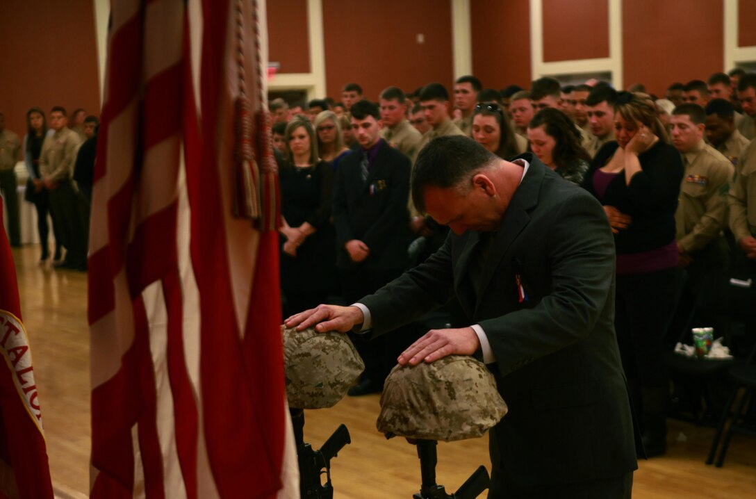 A guest mourns at a memorial set up for two fallen Marines who served with Combat Logistics Battalion 2, 2nd Marine Logistics Group during the unit’s 2012 deployment to Helmand province, Afghanistan. The unit held the memorial aboard Camp Lejeune, N.C., where the families and friends of the fallen Marines joined the servicemembers in honoring the sacrifices of the two Marines. 