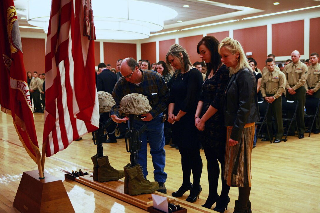 Family members mourn at a memorial set up for two fallen Marines who served with Combat Logistics Battalion 2, 2nd Marine Logistics Group during the unit’s 2012 deployment to Helmand province, Afghanistan. The unit held the memorial aboard Camp Lejeune, N.C., where the families and friends of the fallen Marines joined the unit in honoring the sacrifices of the two servicemembers. 