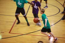 A student from Brewster Middle School dribbles toward the basketball hoop during a Hoops-N-Dreams jamboree aboard Camp Lejeune, N.C., Feb. 22, 2013. The event was one of the first times the students were able to play on an official-size basketball court. 