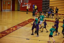 Students from Brewster Middle School watch as one of their peers attempts to score during a Hoops-N-Dreams jamboree aboard Camp Lejeune, N.C, Feb. 22, 2013. The Hoops-N-Dreams program provides the students with mentorship from volunteers across the base and emphases respect as a key tool for the students’ daily lives.