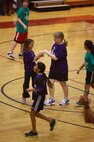 Two students from Brewster Middle School celebrate a scoring drive during a Hoops-N-Dreams jamboree aboard Camp Lejeune, N.C, Feb. 22, 2013. The event stressed teamwork and mutual respect between the participants as they put their teamwork to the test during the game. 