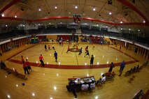 Participants in a Hoops-N-Dreams jamboree dash about a basketball court aboard Camp Lejeune, N.C., Feb. 22, 2013. Four teams of students from Brewster Middle School put their sportsmanship and basketball skills to the test during the event. 