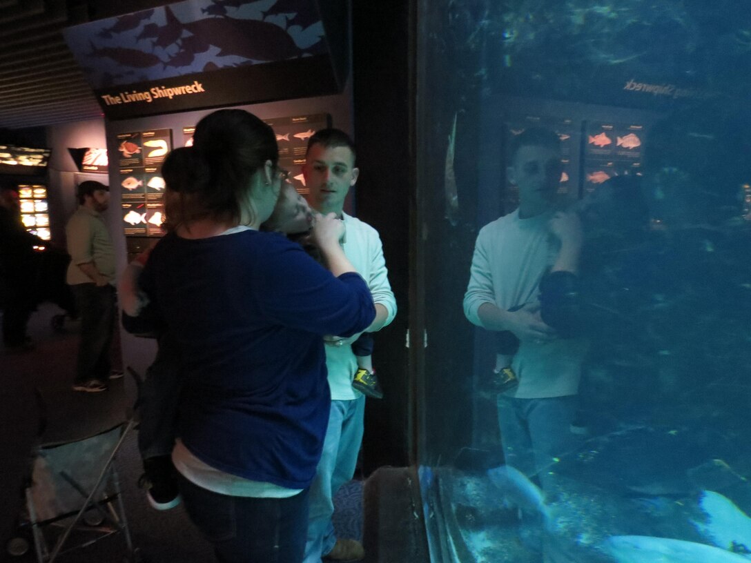 Sgt. Shawn Neal, an aircraft mechanic with Marine Attack Training Squadron 203, and his family look at the shipwreck exhibit at the Pine Knoll Shores Aquarium March 4.