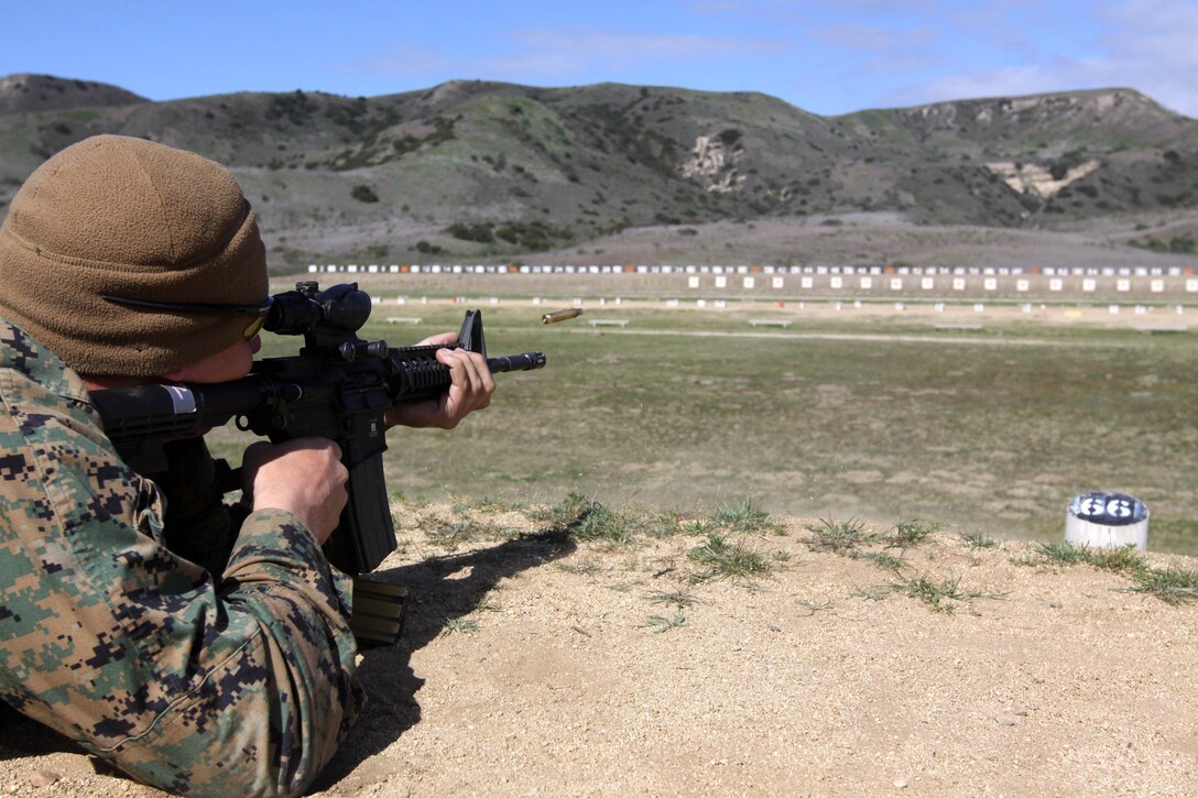 Staff Sgt. Peter Anderson fires an M-4 service rifle during the Western Division Matches held at Wilcox Range here March 6. 

"The Marine Corps Shooting Team has been very helpful in adjusting my standing firing position," said Anderson, the substance abuse control officer of 1st Radio Battalion here. “This is my second year competing in the Division Matches.”
